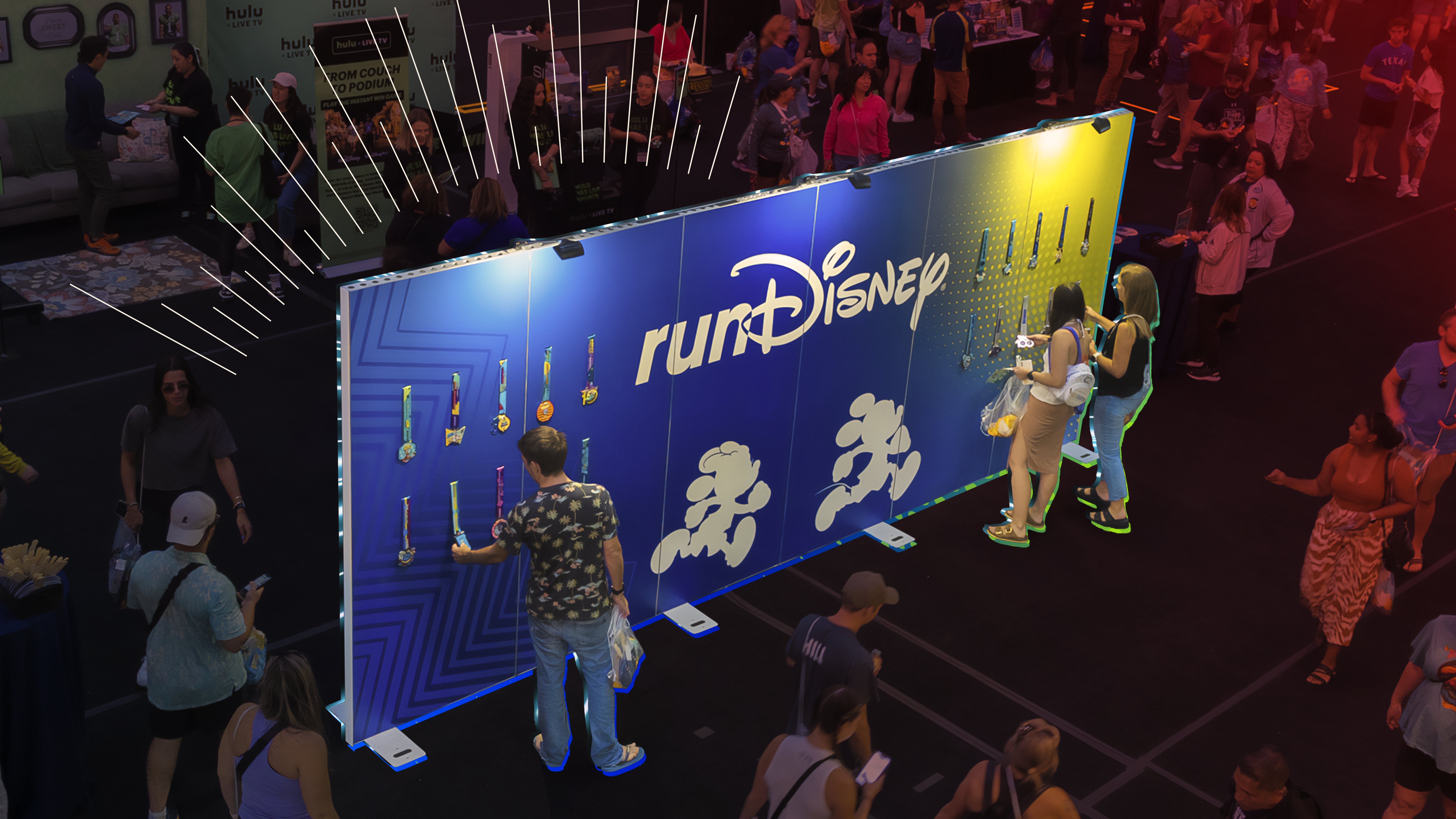 People looking at a wall of medals